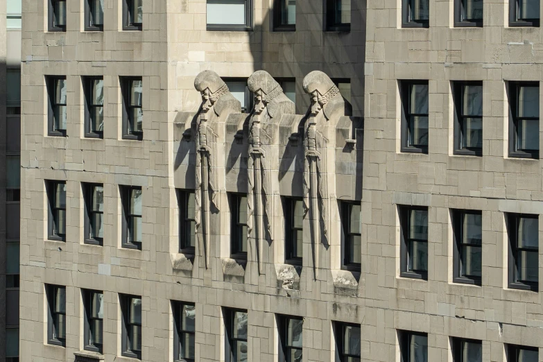 statues on the side of an old, stone building