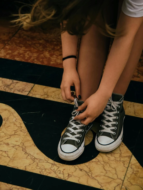 a woman tying her shoes with her fingers