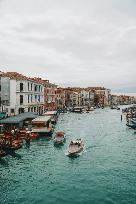 a harbor full of boats with buildings lining the shore