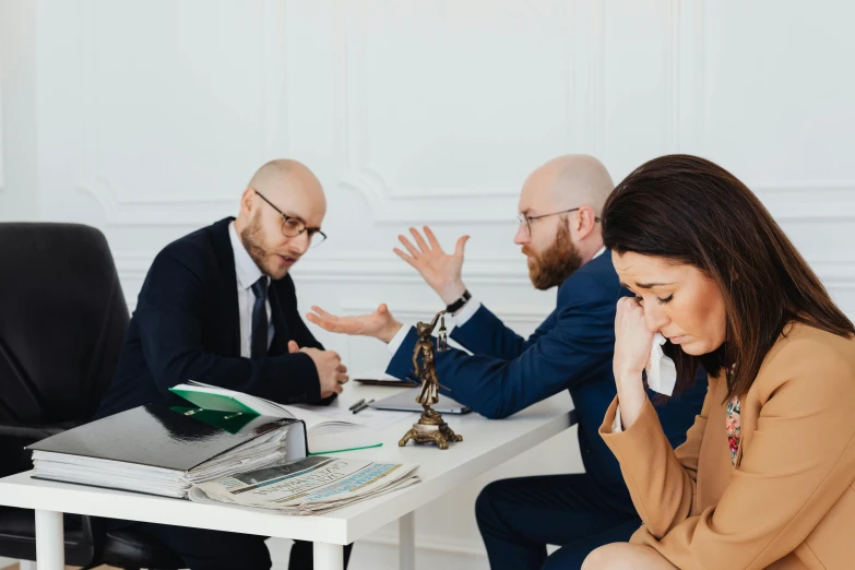 three people are in conversation at a table