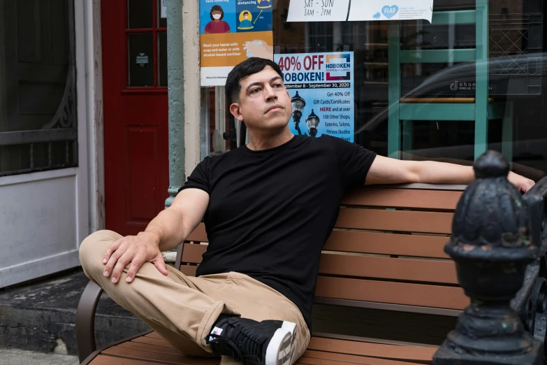 a man is sitting on a park bench