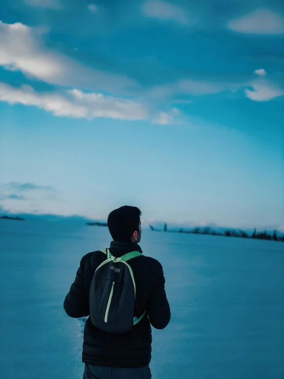 the person is standing outside by the water