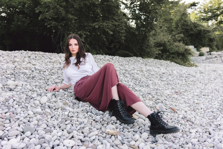 the woman is lying on a rock and posing for a po