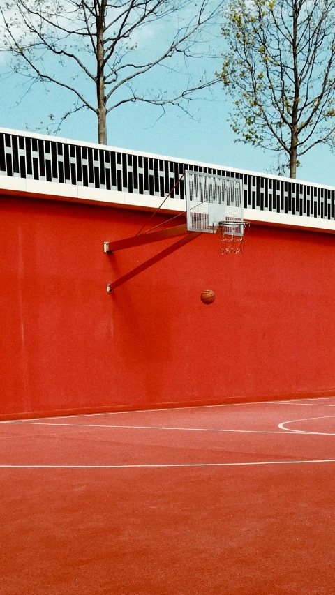 a tennis court with a net on the top and trees in the background