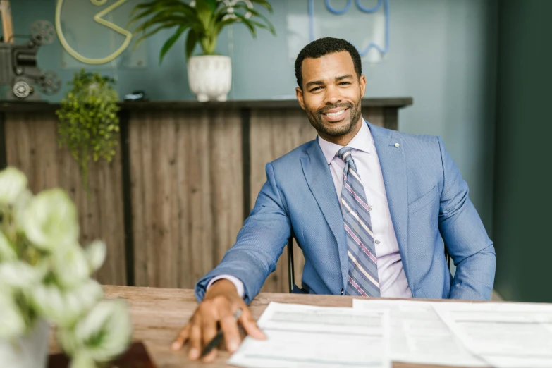 a man sits in an office with a lot of paperwork