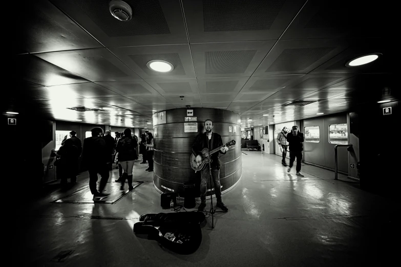 a large room with people, a piano, and various types of instruments