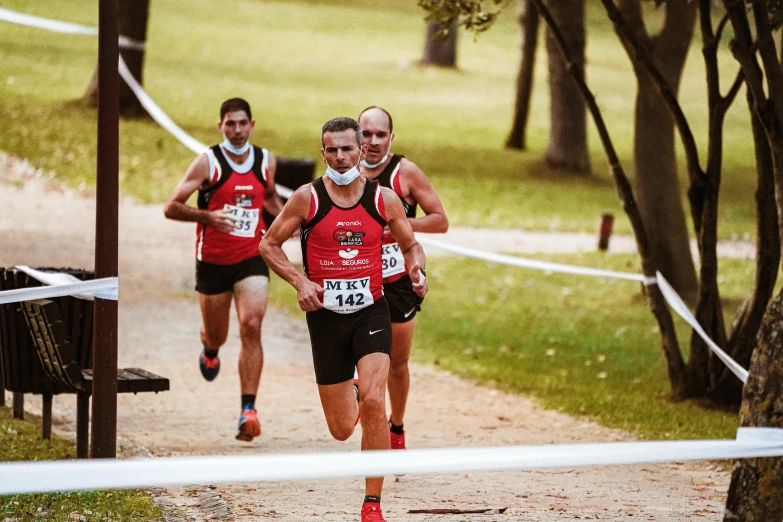 two male marathon runners are approaching the finish line