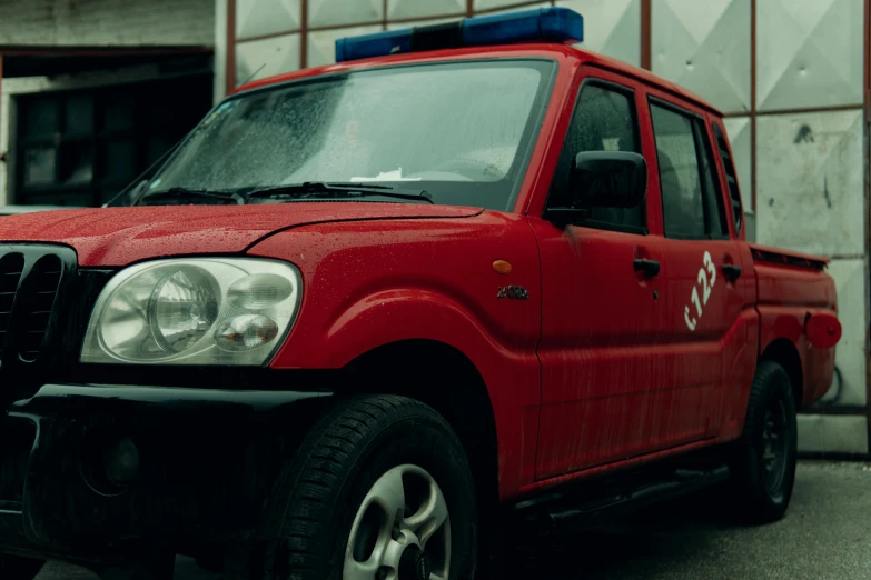 a bright red car is parked by a building