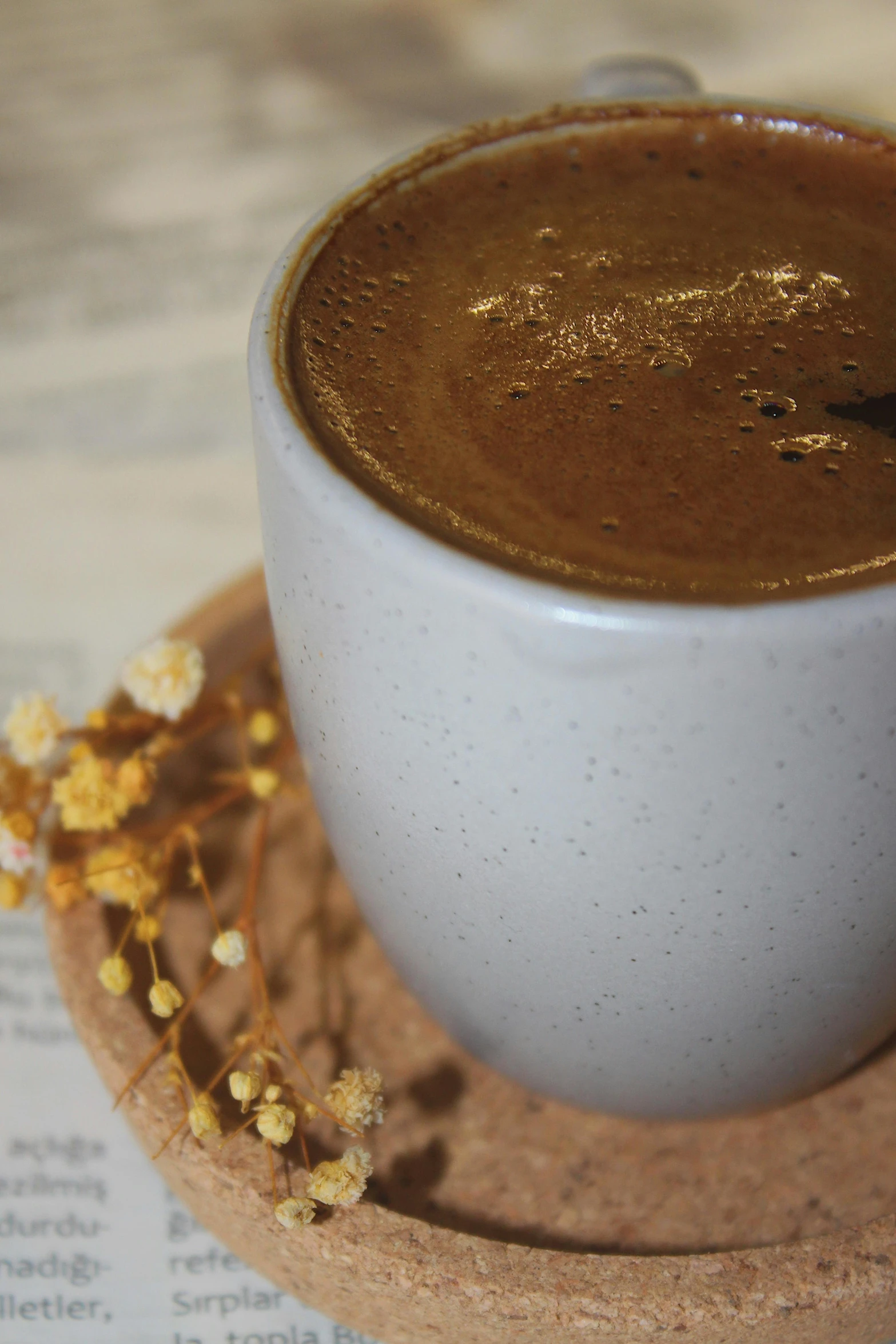 there is a cup of coffee with a little decoration on the table