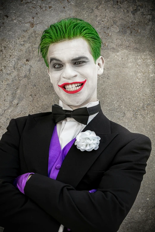 a man dressed as a joker with green hair and makeup