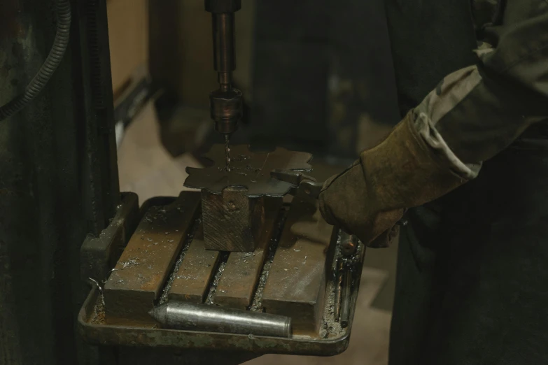 an industrial man operating a machine  some metal