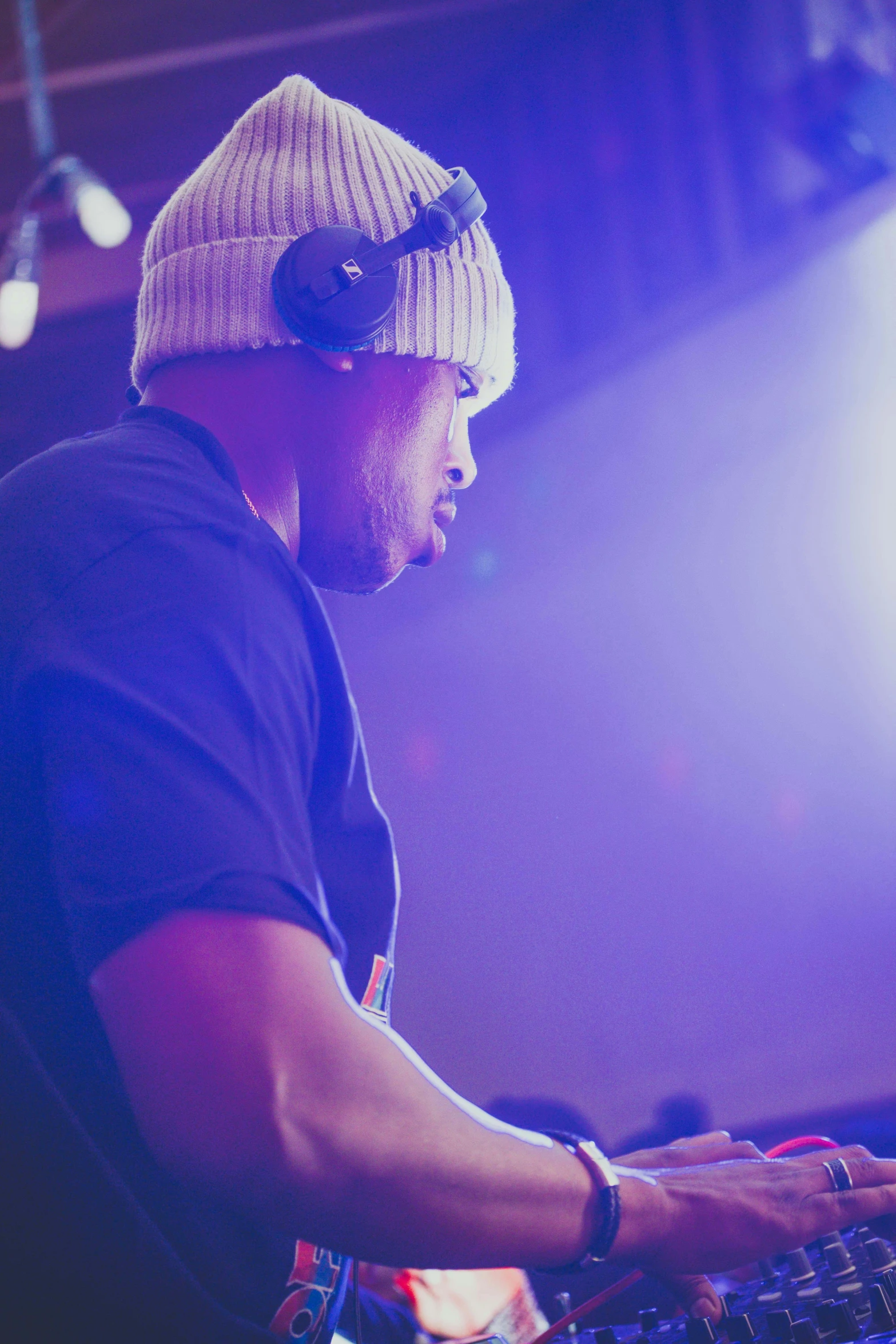 a young man wearing a hat, using a computer