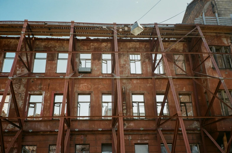 the unfinished facade of a building is red