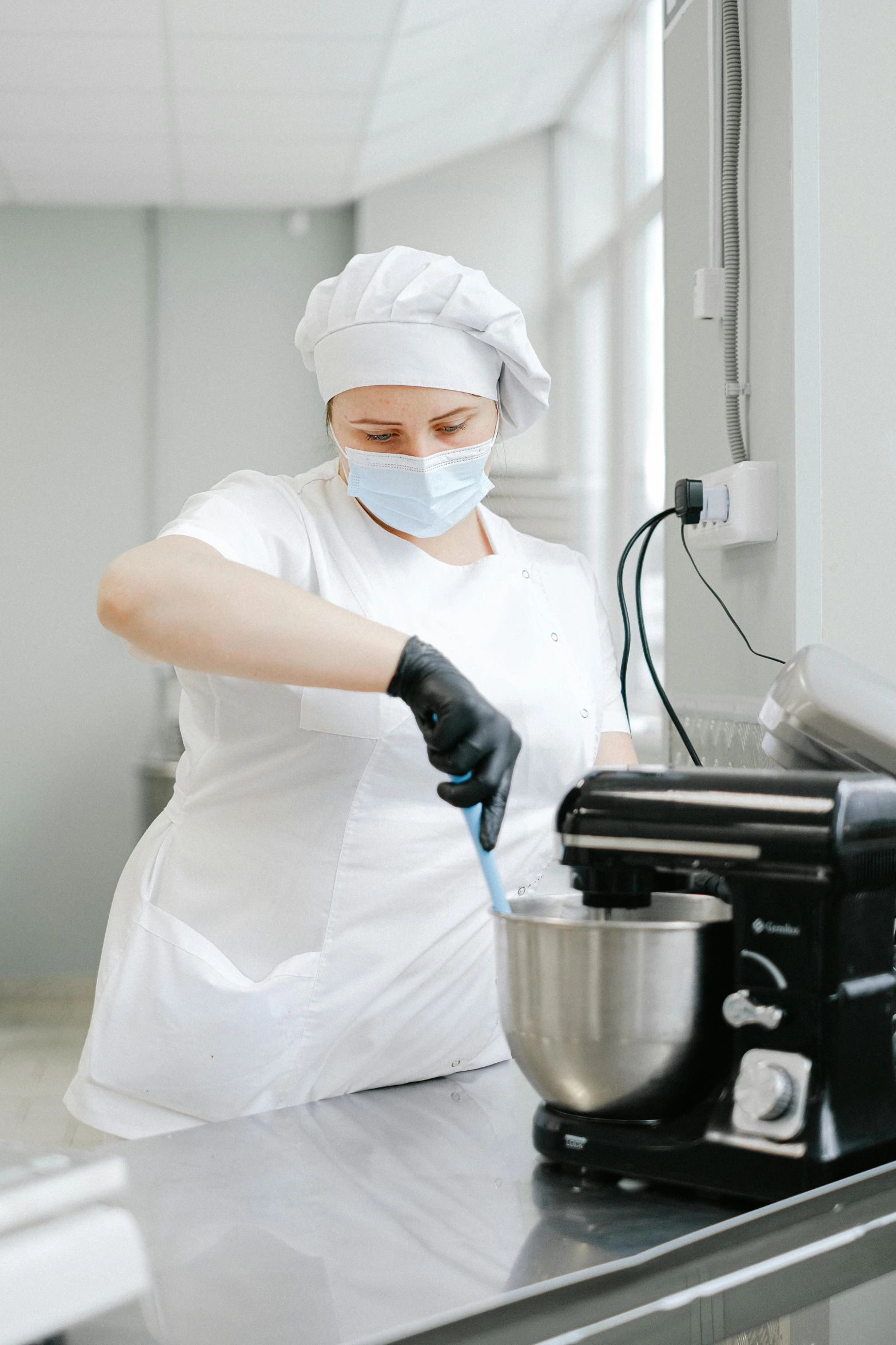 a female chef is preparing food in a commercial kitchen