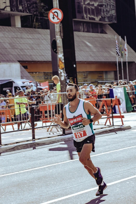 a marathon runner is racing near a fence