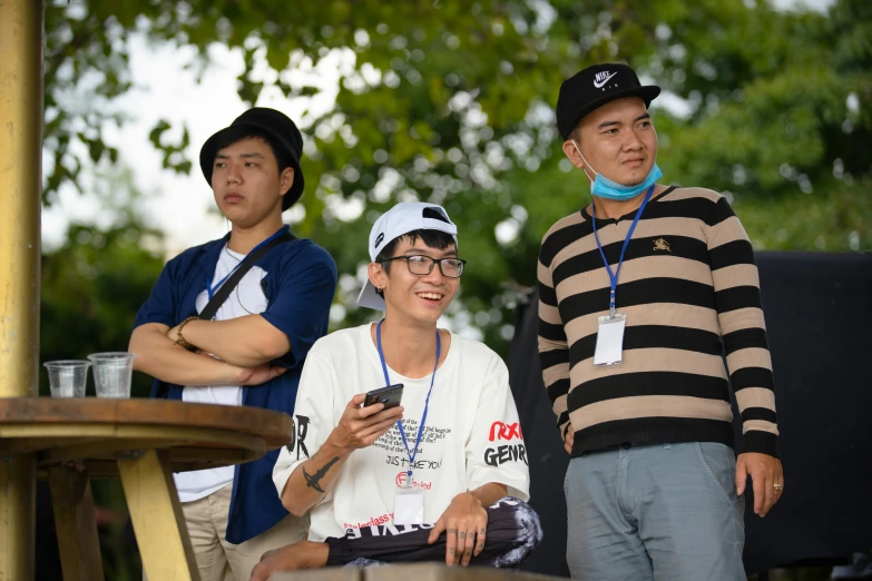 a group of three people standing next to each other