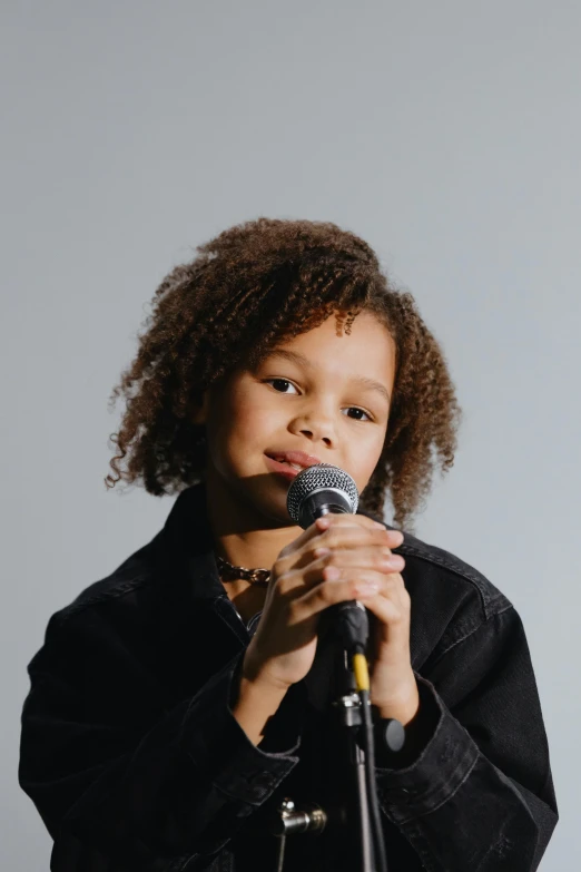 young african american girl holding a microphone in her hands