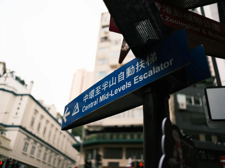 a blue street sign pointing in different directions