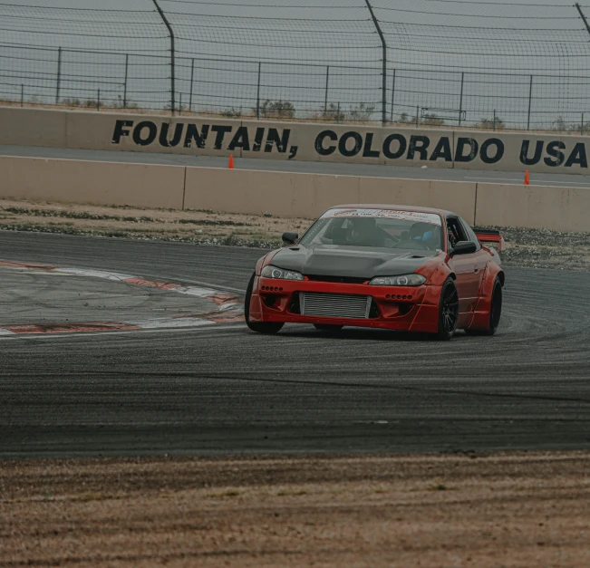 a red sports car driving on a track