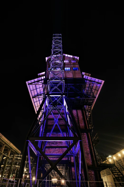 a building illuminated up in blue light at night