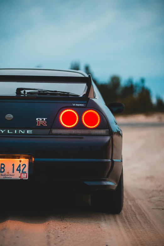 the back end of a car parked on a street