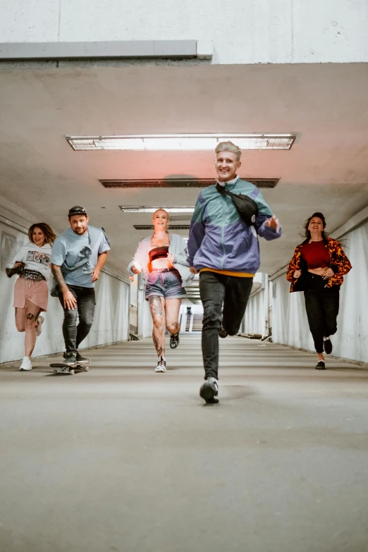 five people are walking through the room together