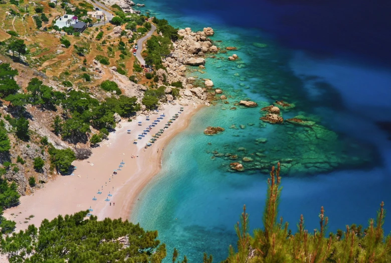 the sandy beach on an island is dotted with shade