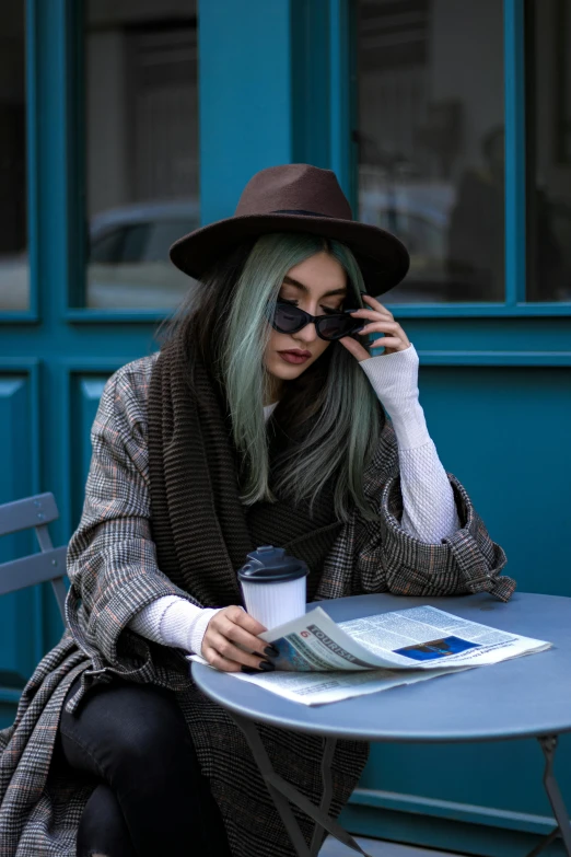 a woman with green hair is talking on the phone