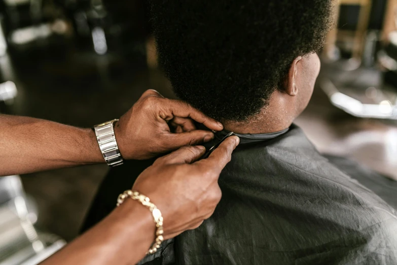 a man  another mans hair with clippers