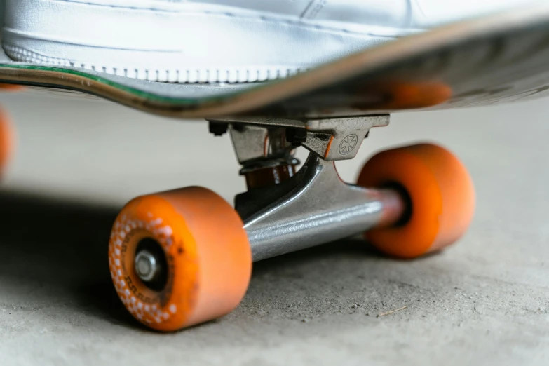 the skateboard has wheels with orange wheels
