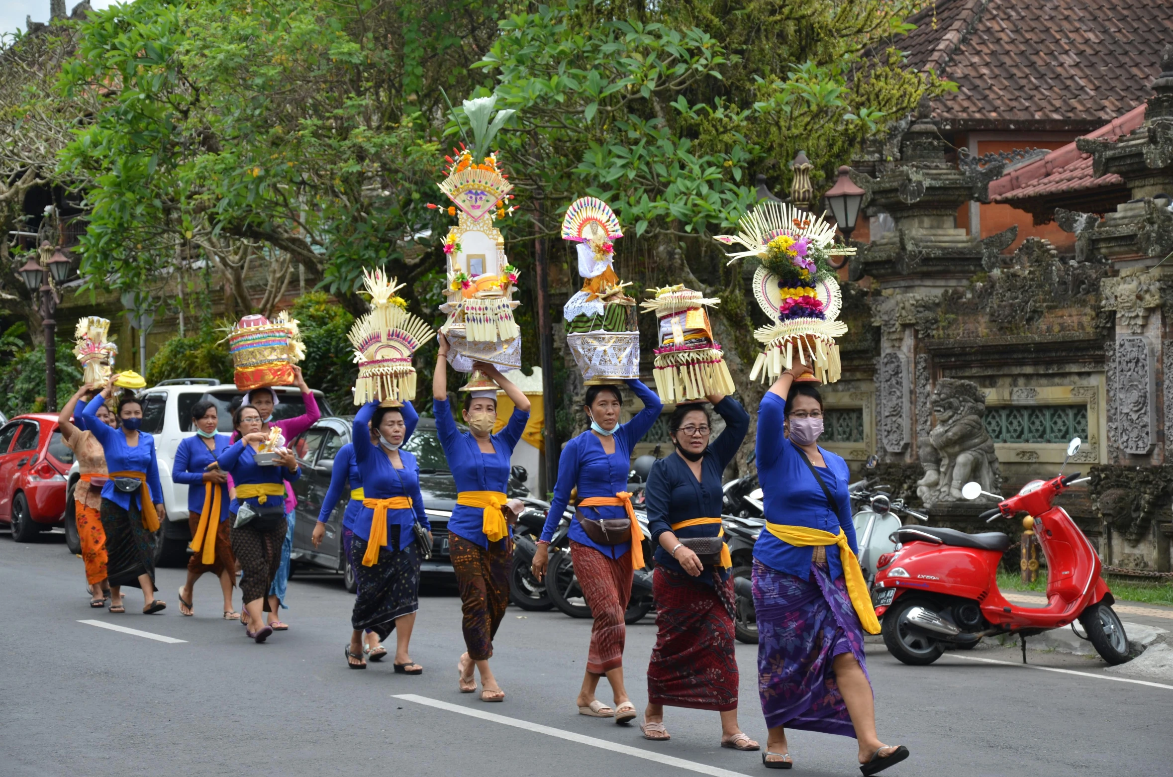 people dressed in blue carrying giant puppets on the street