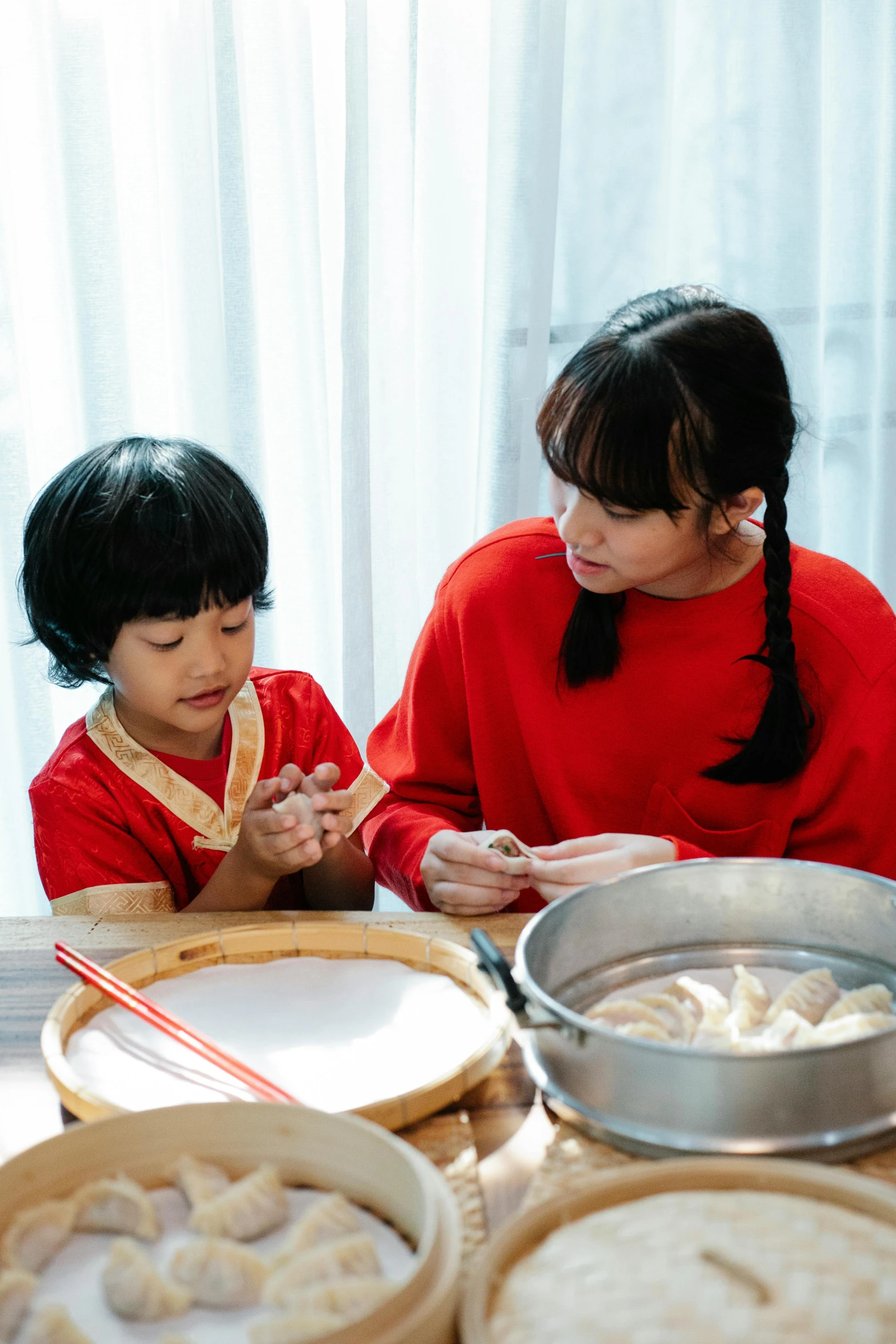 an asian mother and daughter preparing cookies for breakfast