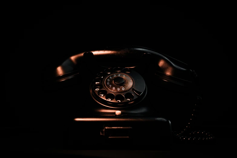 old, dusty looking phone lit up in the dark