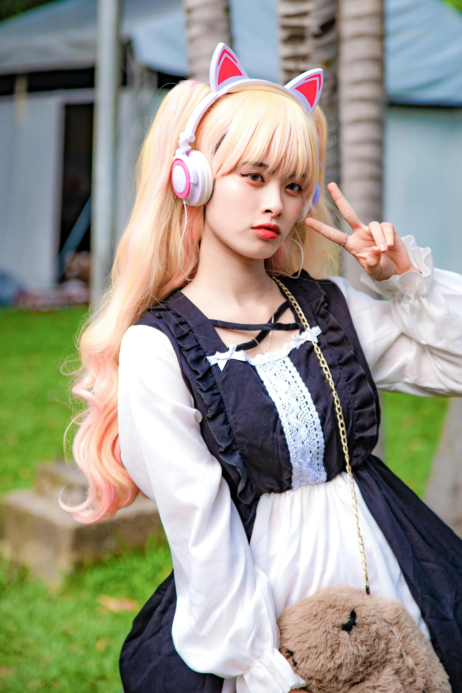 a person standing with a stuffed animal near her ear