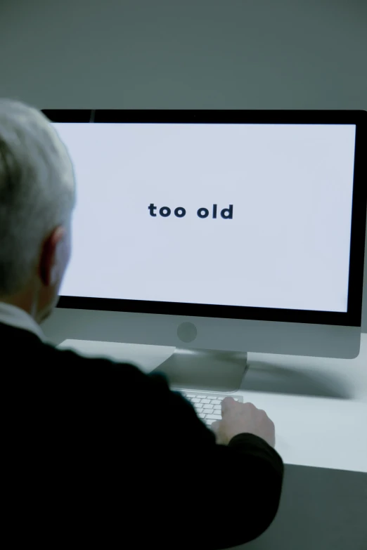 a man typing on a computer screen with a text displayed below