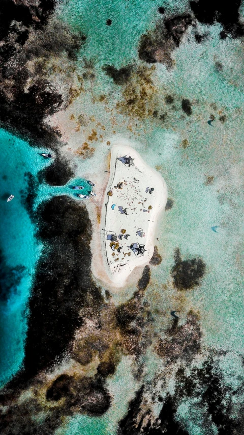 a aerial s of an island in the middle of blue water