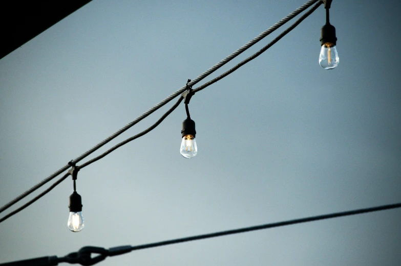 an image of several lights hanging from wires