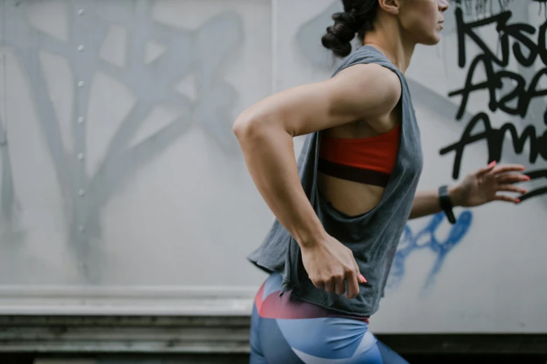 woman running through the street in a athletic outfit