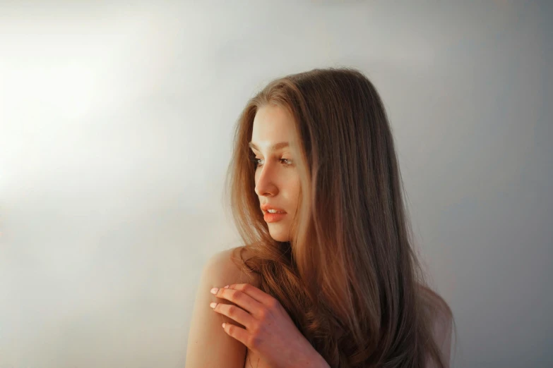 a woman has long brown hair with a toothbrush