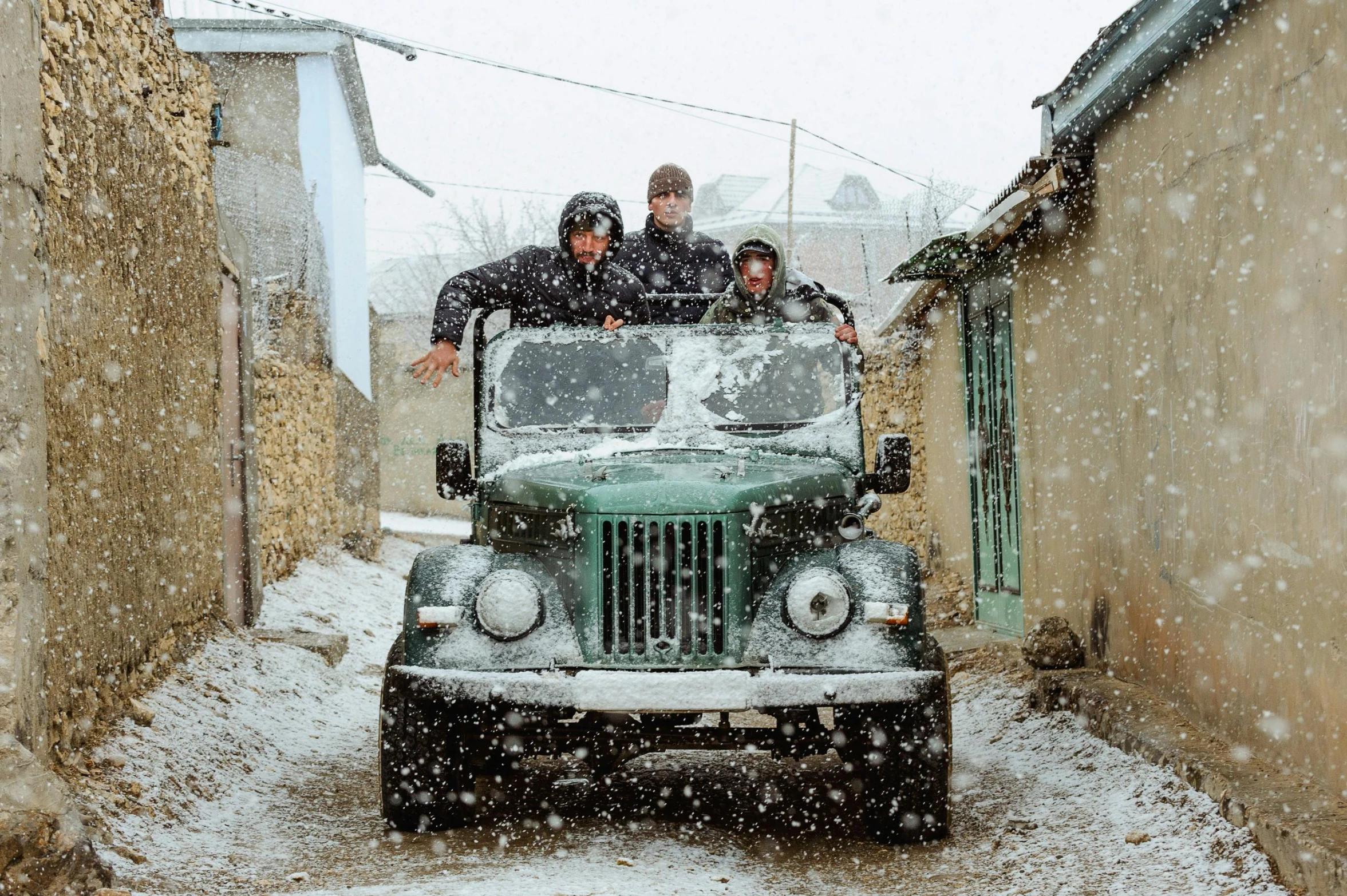 a jeep driving down the road during winter