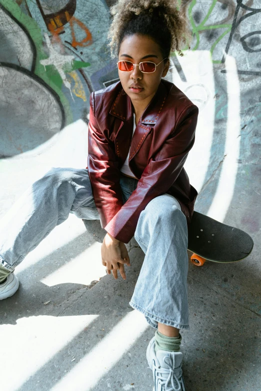 a skateboarder is in front of a wall with graffiti