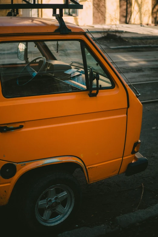 an orange car parked on the side of the road