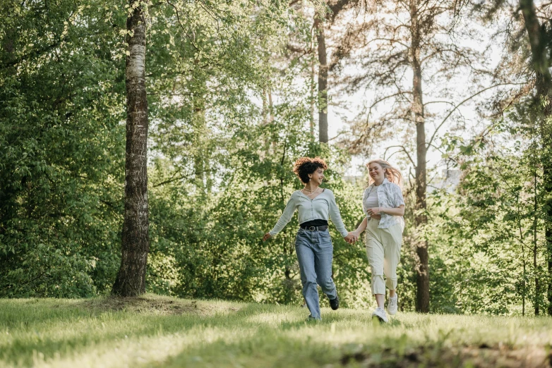 two women who are walking in the woods