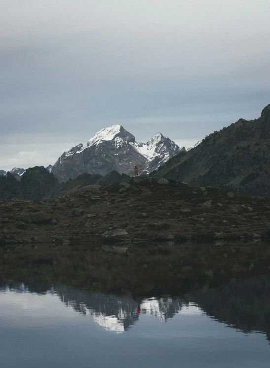 mountains in the background are reflected on the water