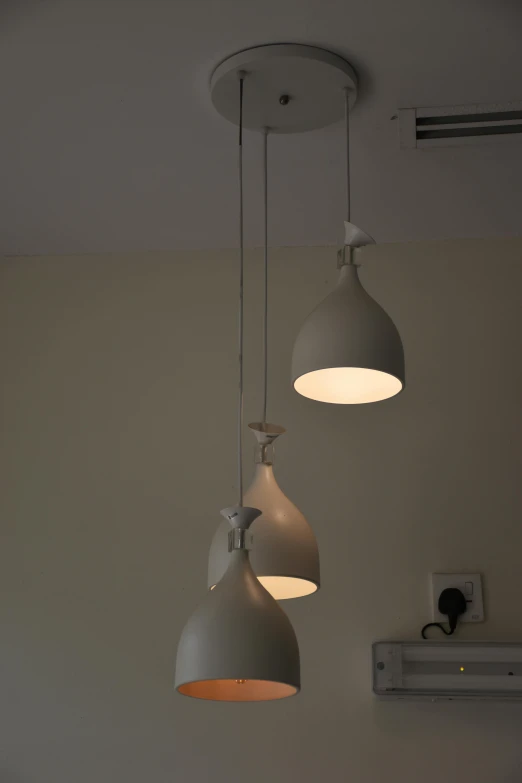 three different lights hanging from an overhead fixture