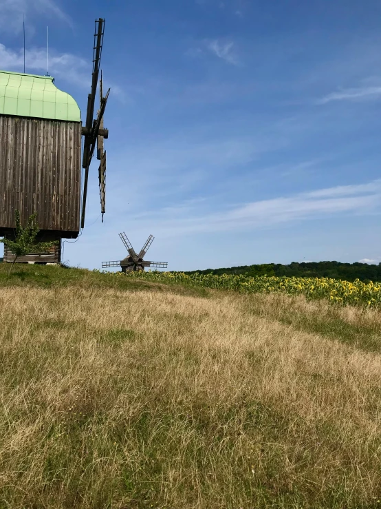 there is a old windmill on the side of this hill