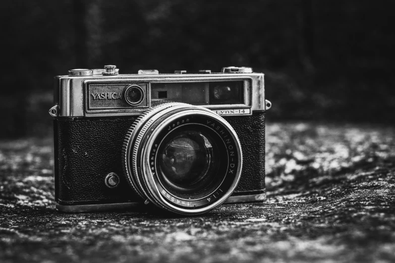 an old black and white po of a camera on a ground
