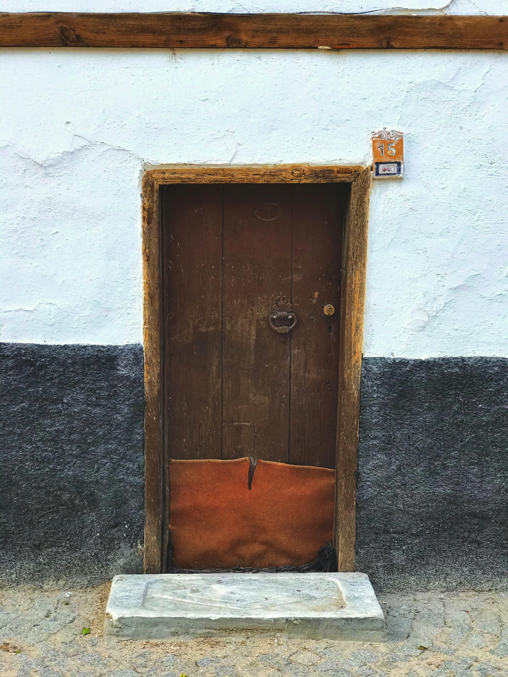 a building has an open door and a white base