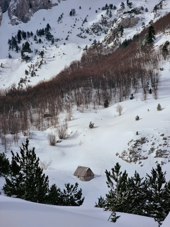 view over the snow - covered hill from atop the slope