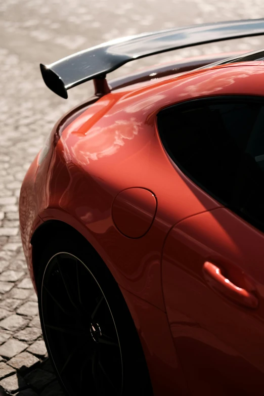 a bright red sports car parked on a street